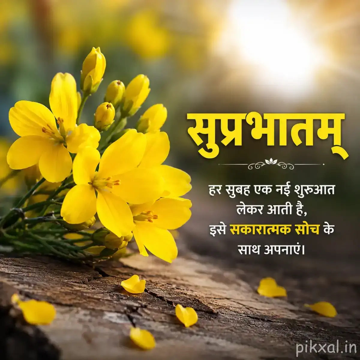 Several yellow flowers with unopened buds on a leafy stem beside a wooden surface and a Hindi Good Morning wish